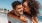 a man and woman embracing on a beach